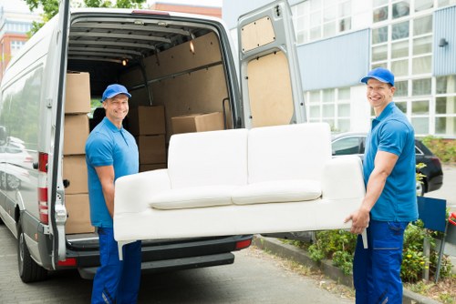 Furniture moving team handling a sofa during a service booking