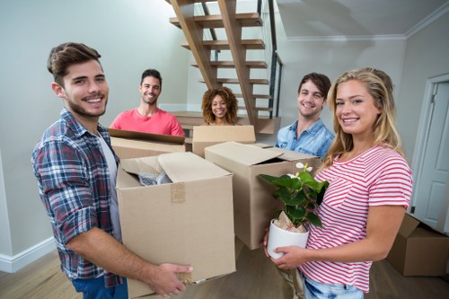 Furniture moving team reviewing a complaint document beside wrapped household items