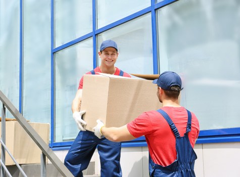 Removal team handling boxes and furniture during a local house move