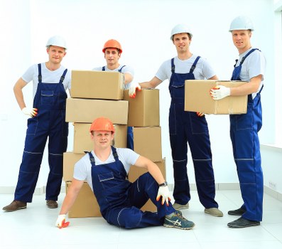 House movers preparing and transporting office furniture for a local business move